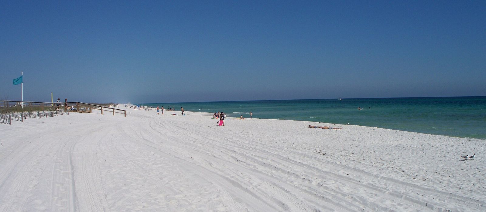 Wide white sand and emerald water at Navarre Beach, Florida